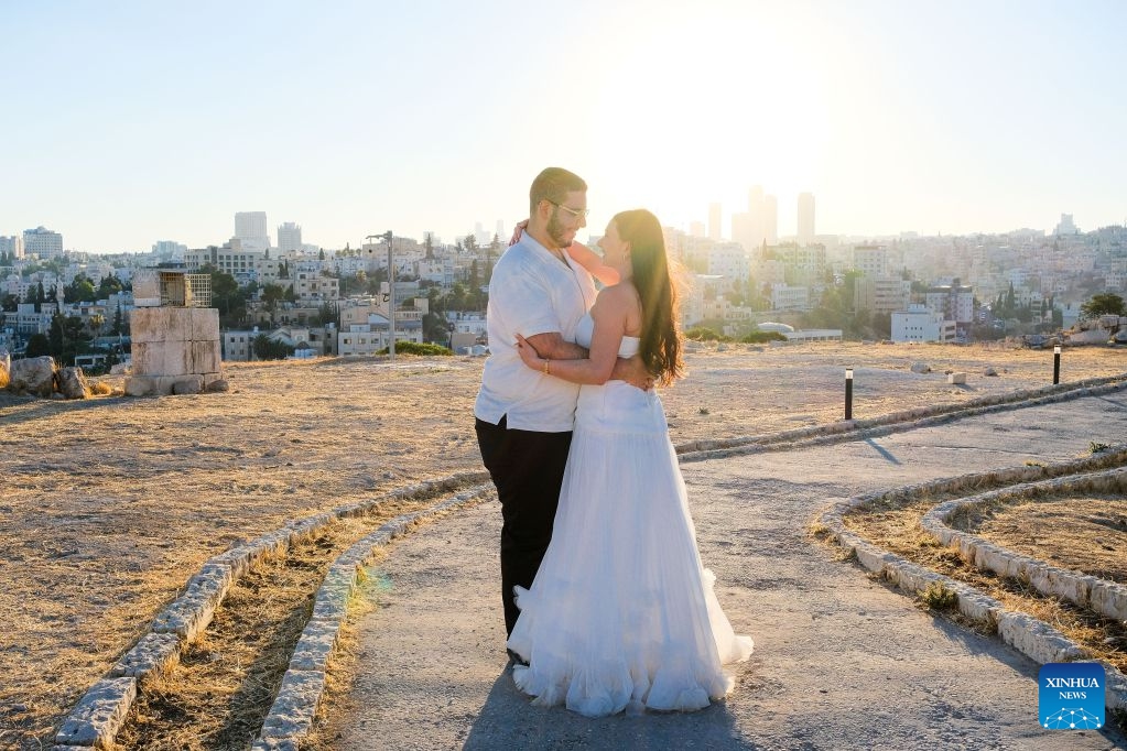 Tourists have wedding photos taken at the Citadel in Amman, Jordan, on July 20, 2026. Amman is the capital of Jordan where tradition and modernity coexist. From the ancient Citadel to the modern shopping district, traces of different eras intertwine to reveal the city's unique charm and enduring vitality. (Xinhua/Xin Mengchen)