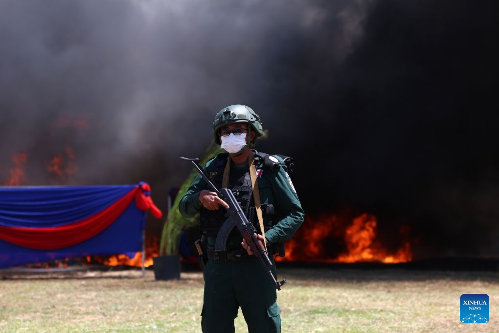 An anti-drug police officer stands guard during a drug-burning ceremony in Kandal province, Cambodia, July 21, 2026. Cambodia destroyed 5.62 tons of illicit drugs and precursor chemicals valued at 500 million U.S. dollars on Tuesday, Deputy Prime Minister and Interior Minister Sar Sokha said. (Photo by Sovannara/Xinhua)