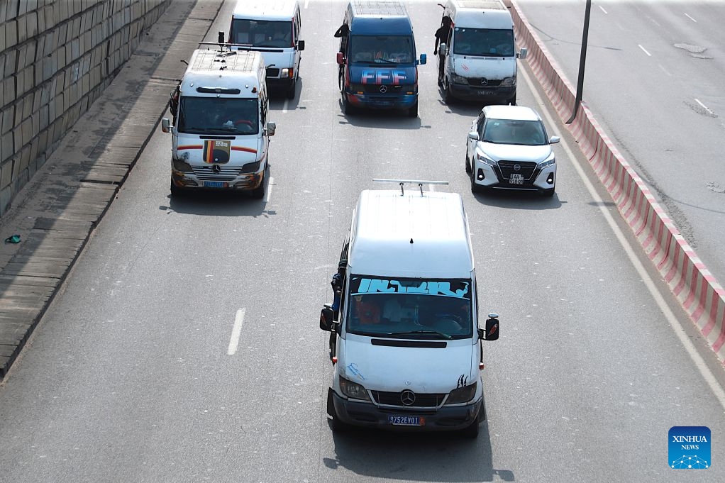 Several minibuses operate on a road in Abidjan, Cote d'Ivoire, on July 21, 2026. Colorful minibuses serve as a primary mode of transport and a vibrant element of local street culture in Abidjan, the economic capital of Cote d'Ivoire. (Photo by Yvan Sonh/Xinhua)