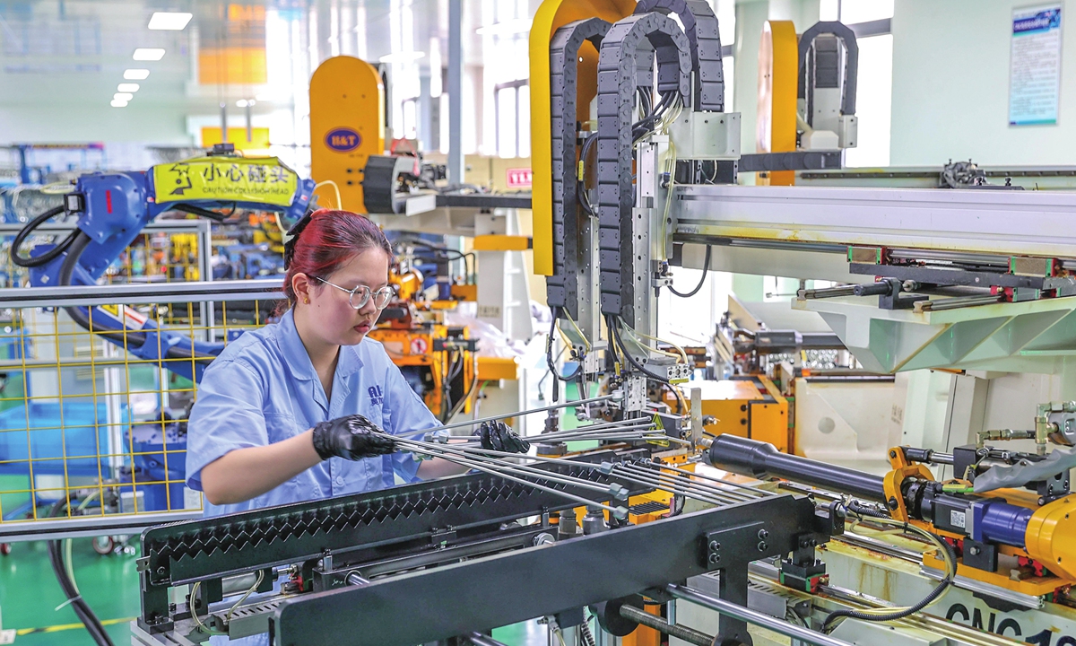 A worker rushes to fill export orders for internal combustion engine parts at a manufacturing company in Deqing county, East China's Zhejiang Province, on July 22, 2026. From January to May, Zhejiang's exports of mechanical and electrical products reached 847.39 billion yuan ($125.41 billion), up 5.9 percent year-on-year and accounting for nearly half of the province's total exports. Photo: VCG.