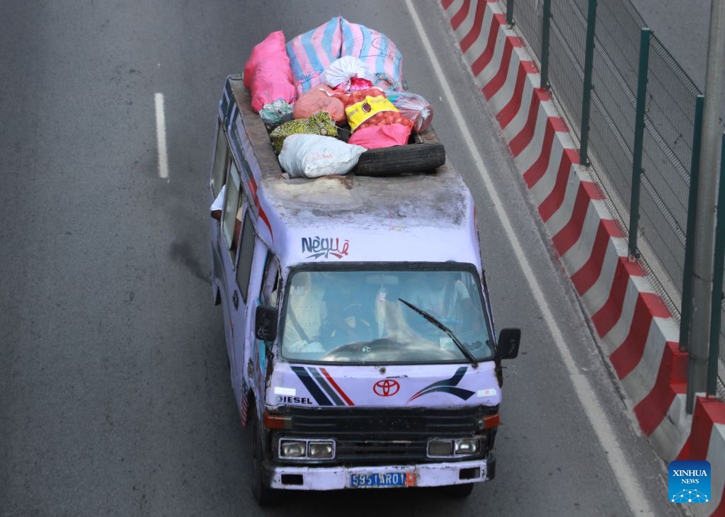A minibus operates on a road in Abidjan, Cote d'Ivoire, on July 21, 2026. Colorful minibuses serve as a primary mode of transport and a vibrant element of local street culture in Abidjan, the economic capital of Cote d'Ivoire. (Photo by Yvan Sonh/Xinhua)