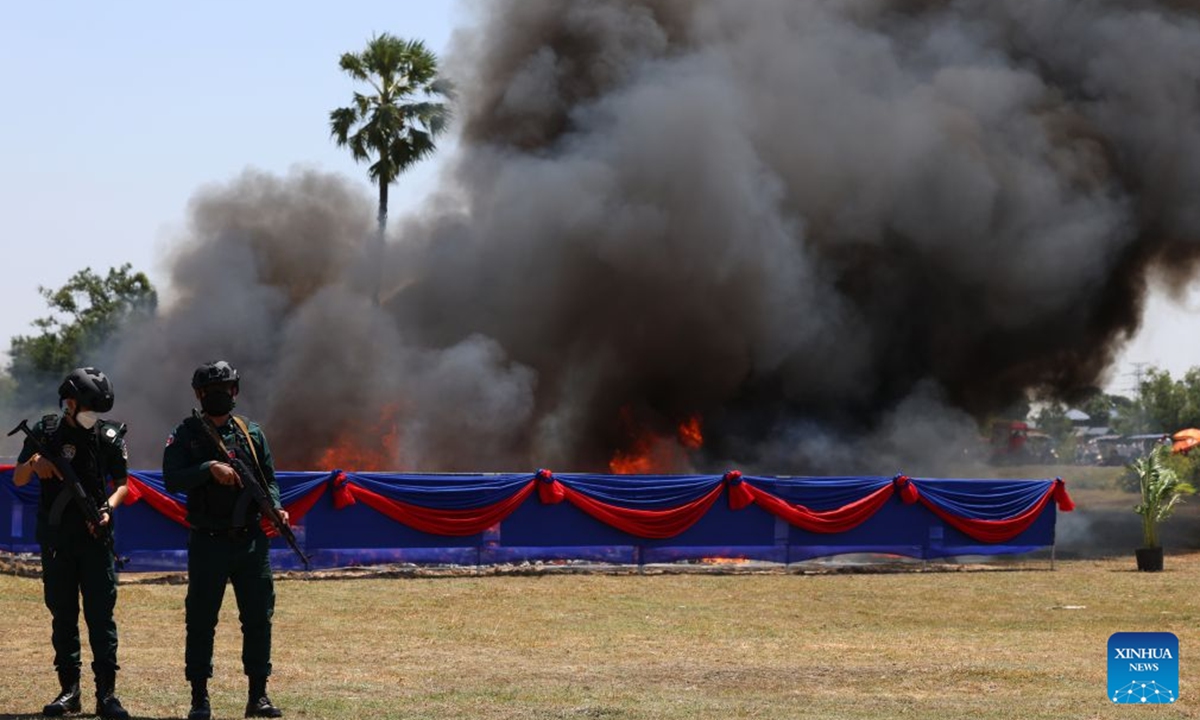 Anti-drug police officers stand guard during a drug-burning ceremony in Kandal province, Cambodia, July 21, 2026. Cambodia destroyed 5.62 tons of illicit drugs and precursor chemicals valued at 500 million U.S. dollars on Tuesday, Deputy Prime Minister and Interior Minister Sar Sokha said. (Photo by Sovannara/Xinhua)