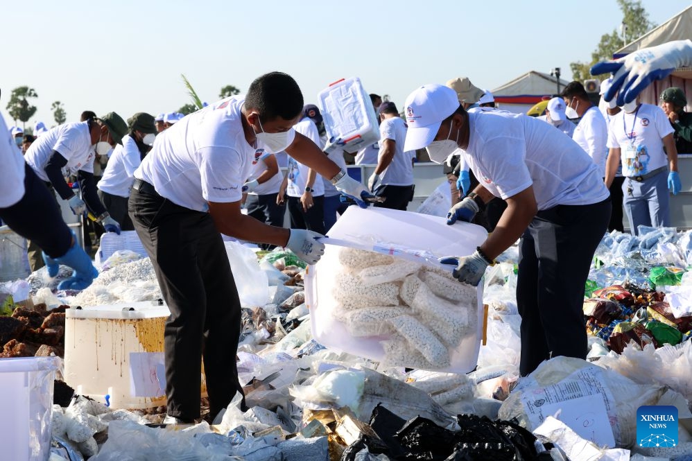 Staff members arrange seized illicit drugs for a drug-burning ceremony in Kandal province, Cambodia, July 21, 2026. Cambodia destroyed 5.62 tons of illicit drugs and precursor chemicals valued at 500 million U.S. dollars on Tuesday, Deputy Prime Minister and Interior Minister Sar Sokha said. (Photo by Sovannara/Xinhua)