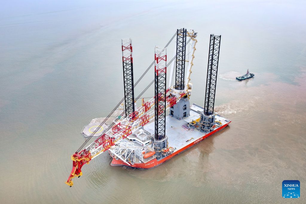 A drone photo taken on July 21, 2026 shows the NG20000 wind turbine installation vessel Fengsheng being officially delivered and setting sail in Qidong, east China's Jiangsu Province.
A vessel customized by COSCO Shipping (Qidong) Offshore Co., Ltd. for a Danish shipping company was officially delivered and set sail on Tuesday.
The vessel features a super-large deck of over 5,600 square meters, a payload of 17,600 tonnes, and a main crane lifting capacity of more than 3,300 tonnes. It is capable of installing wind turbines of 20 megawatts and above. (Photo by Xu Congjun/Xinhua)