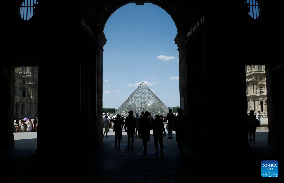 Tourists are pictured near the Louvre Museum in Paris, France, July 21, 2026. The Apollo Gallery at the Louvre Museum, which was robbed in October 2025, is set to reopen to the public on Wednesday, with no jewelry to be displayed, French media reported on Monday. (Xinhua/Wu Huiwo)