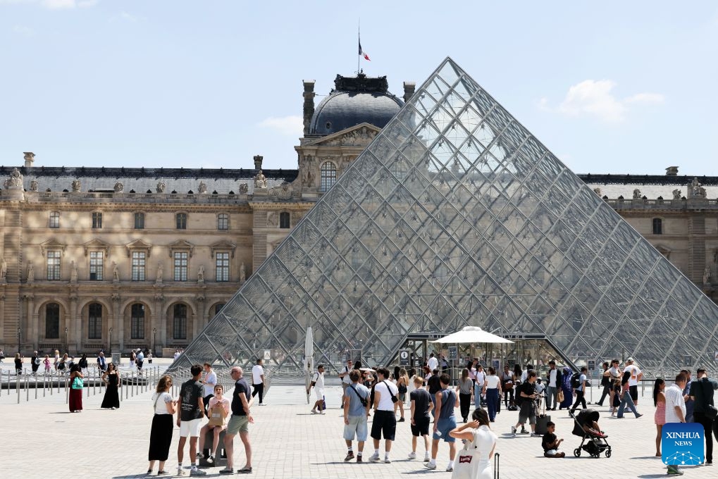 Tourists are pictured near the Louvre Museum in Paris, France, July 21, 2026. The Apollo Gallery at the Louvre Museum, which was robbed in October 2025, is set to reopen to the public on Wednesday, with no jewelry to be displayed, French media reported on Monday. (Xinhua/Wu Huiwo)