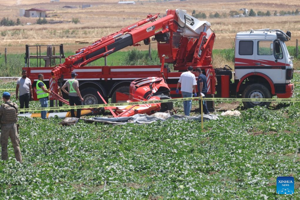 Emergency service personnel work at the site where a training helicopter crashed in the Temelli neighborhood, in Ankara, Türkiye, on July 22, 2026. One pilot was killed and another injured when a training helicopter crashed in Türkiye's capital Ankara on Wednesday, authorities said. (Mustafa Kaya/Handout via Xinhua)