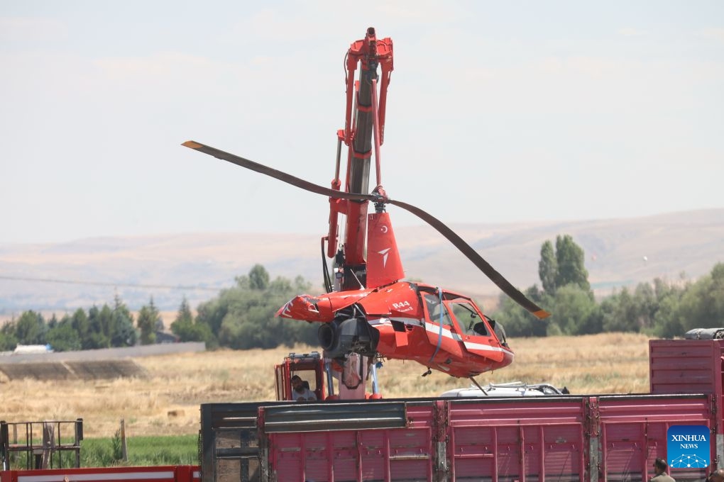 Emergency service personnel work at the site where a training helicopter crashed in the Temelli neighborhood, in Ankara, Türkiye, on July 22, 2026. One pilot was killed and another injured when a training helicopter crashed in Türkiye's capital Ankara on Wednesday, authorities said. (Mustafa Kaya/Handout via Xinhua)