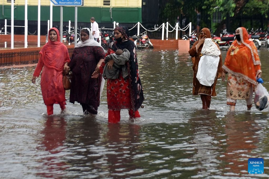 People wade through a flooded street after heavy monsoon rains in Lahore, Pakistan, July 22, 2026.

At least eight people were killed and 16 others injured in rain-related incidents across Pakistan over the past 24 hours as monsoon showers continued to batter parts of the country, the National Disaster Management Authority said on Tuesday. (Photo by Sajjad/Xinhua)
