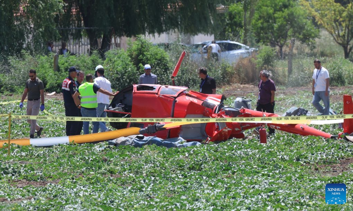 Emergency service personnel work at the site where a training helicopter crashed in the Temelli neighborhood, in Ankara, Türkiye, on July 22, 2026. One pilot was killed and another injured when a training helicopter crashed in Türkiye's capital Ankara on Wednesday, authorities said. (Mustafa Kaya/Handout via Xinhua)