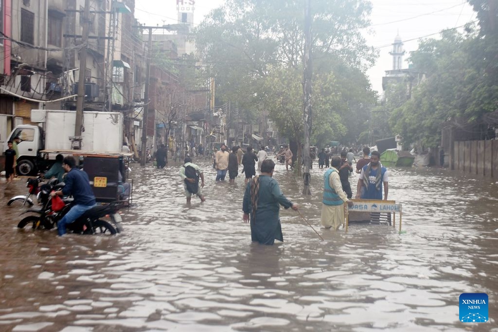 People wade through a flooded street after heavy monsoon rains in Lahore, Pakistan, July 22, 2026.

At least eight people were killed and 16 others injured in rain-related incidents across Pakistan over the past 24 hours as monsoon showers continued to batter parts of the country, the National Disaster Management Authority said on Tuesday. (Photo by Sajjad/Xinhua)