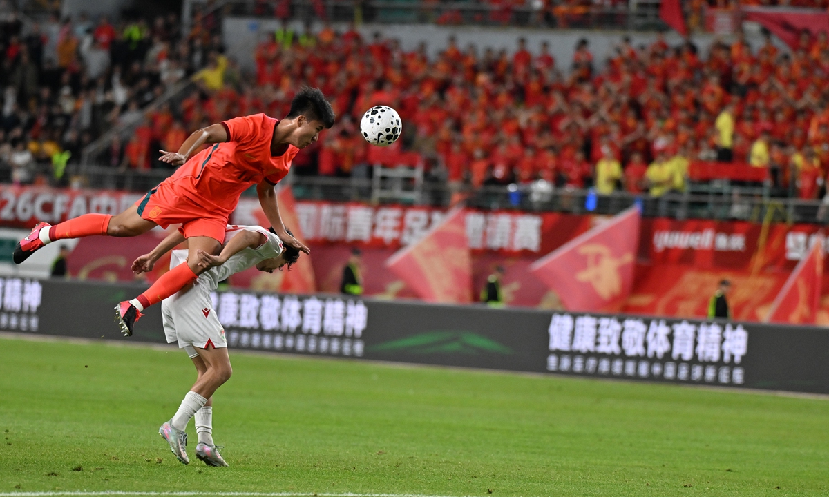 A Chinese under-23 player vies for a header during a friendly match against the Tajik U23 team in Guiyang, Southwest China's Guizhou Province, on June 9, 2026.   Photo: VCG