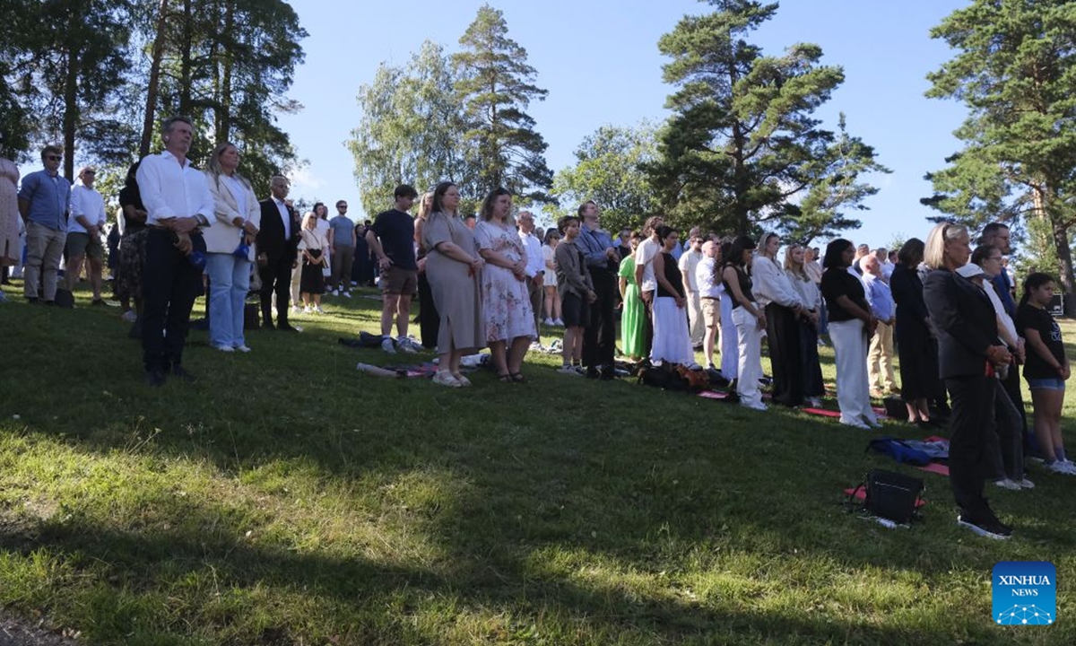 People observe a moment of silence during a memorial event marking the 15th anniversary of the July 22, 2011 terror attacks on Utoya Island, Norway, July 22, 2026. Norwegian Prime Minister Jonas Gahr Store on Wednesday warned of the growing threat of far-right radicalization among young people, saying social media, artificial intelligence and social isolation were fueling extremism, as the country marked the 15th anniversary of the July 22, 2011 terror attacks. (Xinhua/Zhang Yuliang)