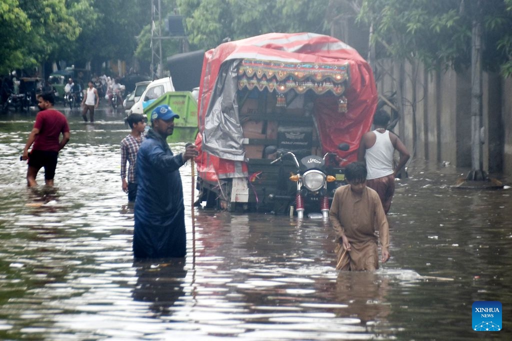 People wade through a flooded street after heavy monsoon rains in Lahore, Pakistan, July 22, 2026.

At least eight people were killed and 16 others injured in rain-related incidents across Pakistan over the past 24 hours as monsoon showers continued to batter parts of the country, the National Disaster Management Authority said on Tuesday. (Photo by Sajjad/Xinhua)