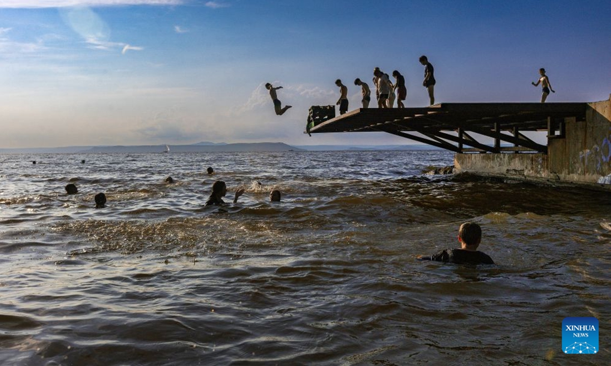 People jump into the sea to cool off in Vladivostok, Russia, July 22, 2026. (Photo by Andrey Matveenko/Xinhua)