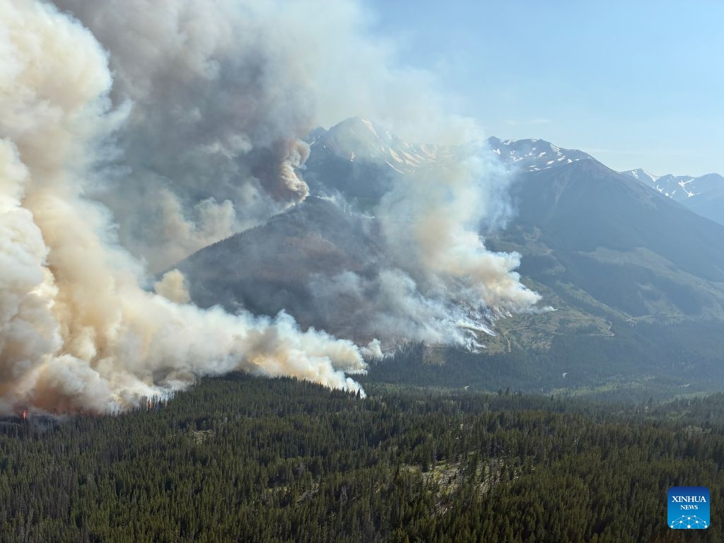 An aerial photo provided by the BC Wildfire Service on July 22, 2026 shows a wildfire near Bonanza Creek in British Columbia, Canada. (BC Wildfire Service/Handout via Xinhua)