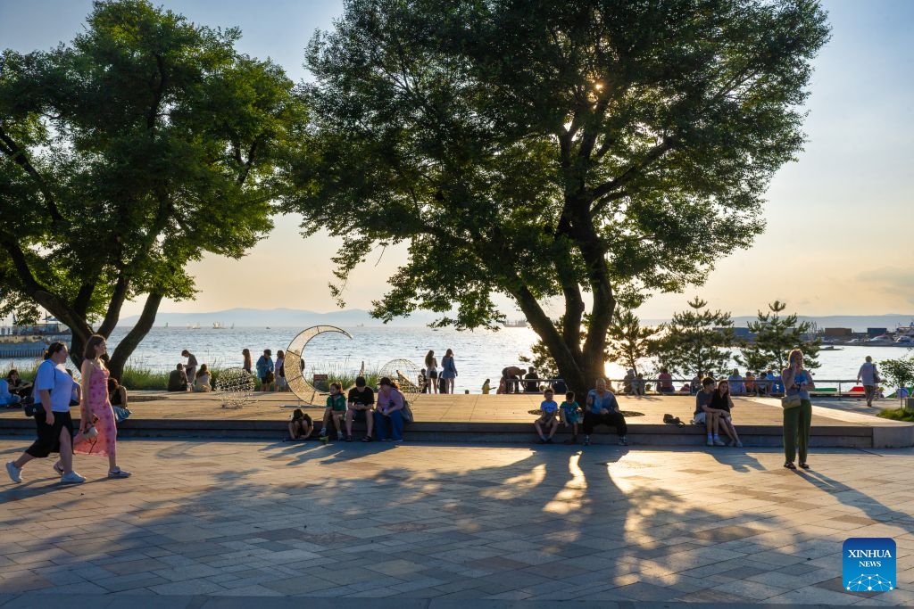 People enjoy their leisure time by the seashore in Vladivostok, Russia, July 22, 2026. (Photo by Andrey Matveenko/Xinhua)