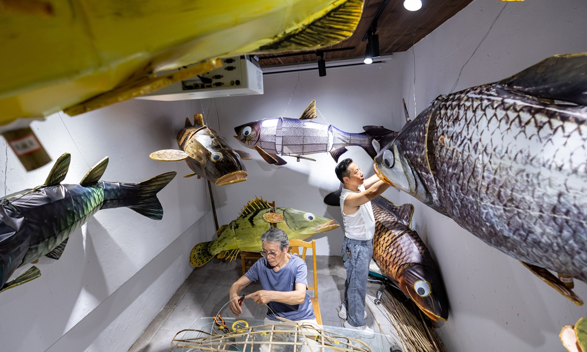 Folk craftsmen make fish lanterns in a workshop in Linghu, East China's Zhejiang Province, on July 23, 2026. Photo: VCG