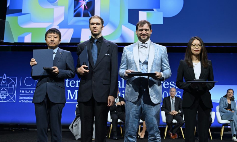 Fields Medalists Deng Yu (1st L) and Wang Hong (1st R), both Chinese mathematicians, John Pardon (2nd L), an American mathematician, and Jacob Tsimerman, a Canadian mathematician, pose for a group photograph at the opening ceremony of the 2026 International Congress of Mathematicians in Philadelphia, the United States, July 23, 2026. Chinese mathematicians Deng Yu and Wang Hong were awarded the Fields Medals at the opening ceremony of the 2026 International Congress of Mathematicians held on Thursday, marking the first time Chinese mathematicians have won the prestigious honor. (Xinhua/Li Rui)