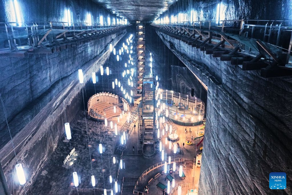 This photo taken on July 23, 2026 shows a view of a defunct salt mine in Turda, Romania. As a new heat wave sweeps across Europe, the defunct salt mine in Turda has become a popular retreat for visitors seeking to escape the summer heat.

Featuring recreational facilities such as rowboats, a Ferris wheel and billiard tables, the salt mine maintains a year-round temperature of around 10 to 12 degrees Celsius. (Xinhua/Yao Yulin)