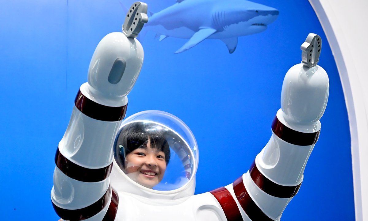 A student visits the China Science and Technology Museum and takes photos in Beijing on July 22, 2026. Photo: VCG