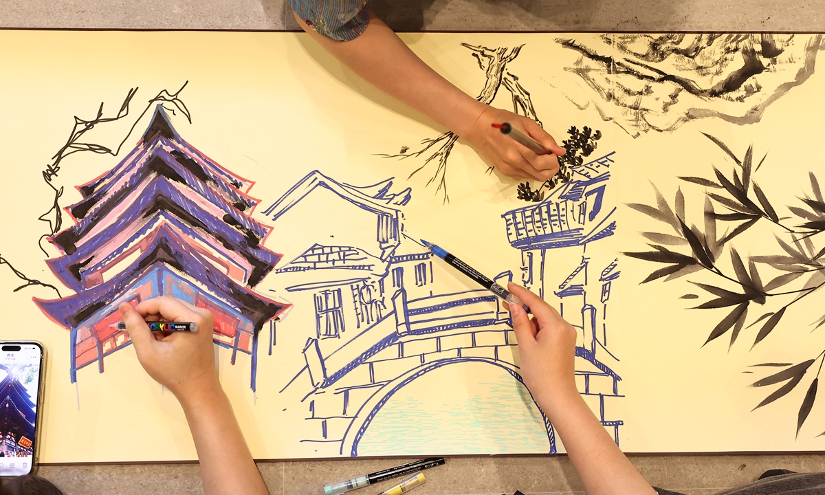 Young people from both sides of the Taiwan Straits jointly paint a long scroll at the opening event of the 2026 Cross-Straits Youth Culture Month in Suzhou, East China's Jiangsu Province, on July 15, 2026.
