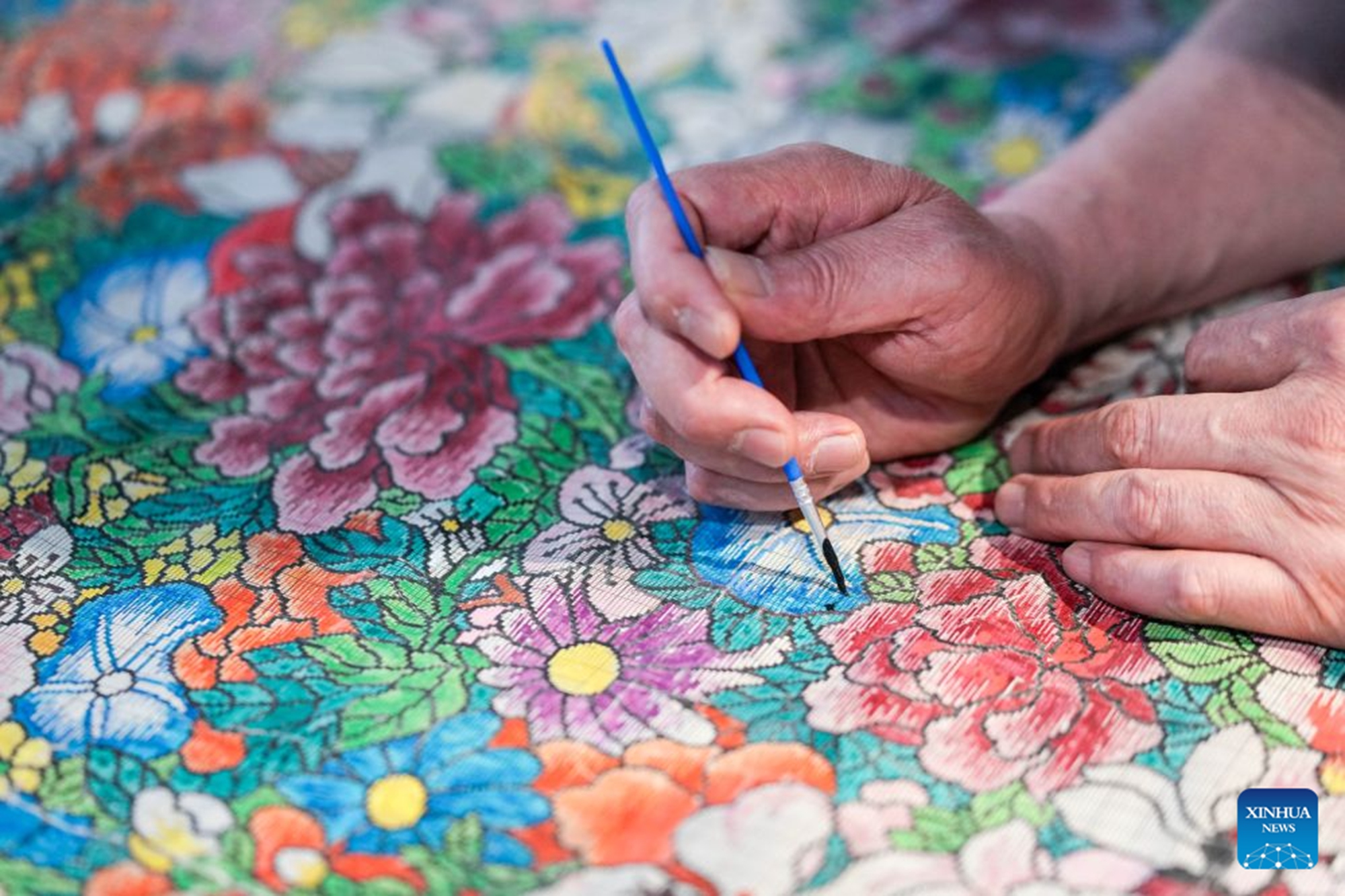 Zhou Shuangxi is pictured while designing Yunjin patterns at the demonstration area of Nanjing Yunjin Brocade Museum in Nanjing, east China's Jiangsu Province, June 11, 2026. (Xinhua/Li Bo)

