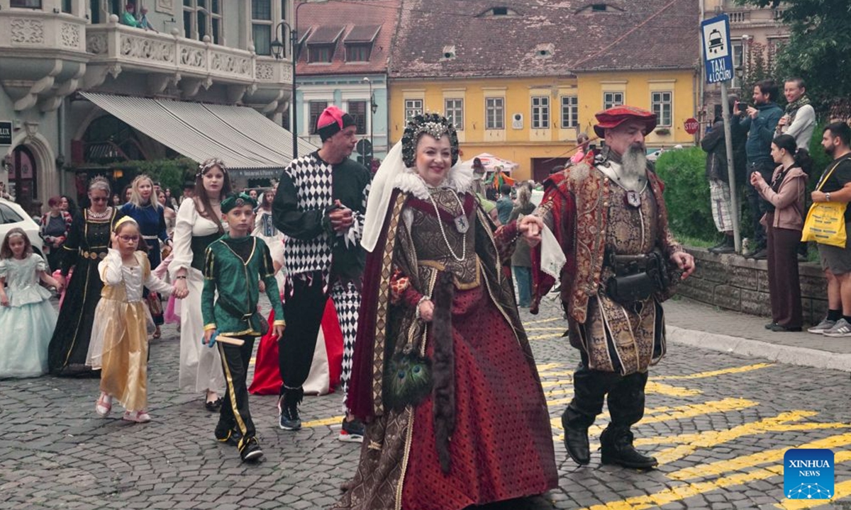 Local residents attend a parade during the Sighisoara Medieval Festival in Sighisoara, Romania, July 24, 2026. The annual Sighisoara Medieval Festival kicked off here on Friday and will last until Sunday. First launched in 1992, the festival is now a distinctive historical celebration in Europe, which revives medieval culture and traditions through various activities. The historic center of Sighisoara was inscribed as a UNESCO World Heritage in 1999. (Xinhua/Yao Yulin)