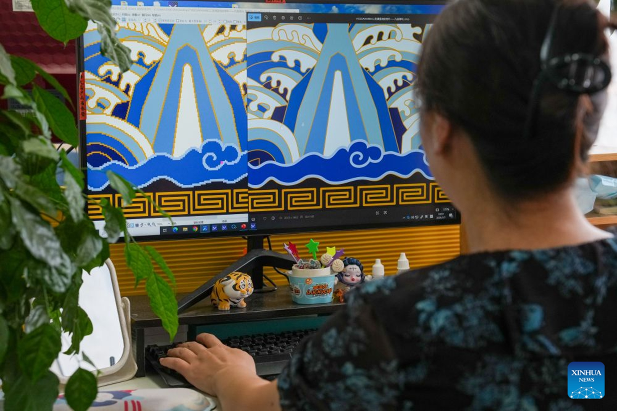 Zhang Ju, senior Yunjin pattern designer of Nanjing Yunjin Brocade Museum, designs new patterns with a CAD software for Yunjin weaving in Nanjing, east China's Jiangsu Province, July 7, 2026. (Xinhua/Li Bo)

