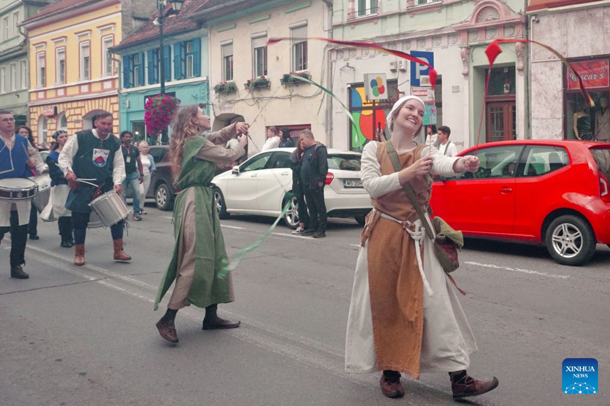 Local residents attend a parade during the Sighisoara Medieval Festival in Sighisoara, Romania, July 24, 2026. The annual Sighisoara Medieval Festival kicked off here on Friday and will last until Sunday. First launched in 1992, the festival is now a distinctive historical celebration in Europe, which revives medieval culture and traditions through various activities. The historic center of Sighisoara was inscribed as a UNESCO World Heritage in 1999. (Xinhua/Yao Yulin)