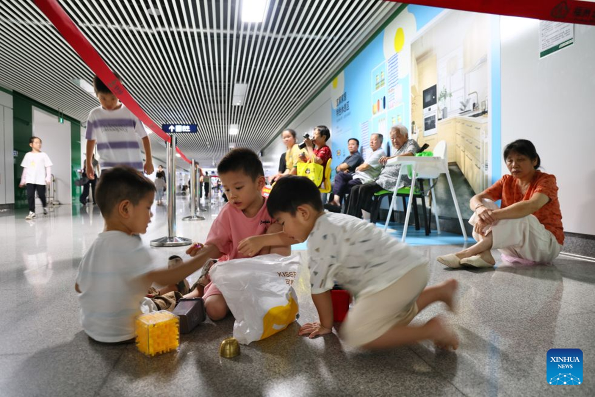 Residents relax at an air-raid shelter to cool off in Fuzhou, southeast China's Fujian Province, July 23, 2026. As summer temperatures soar, Fuzhou has made some tunnels, air-raid shelters and metro stations available as public cooling spaces. Equipped with benches, chairs and other convenience facilities, these sites have become popular for residents to relax and escape the heat. (Xinhua/Jiang Kehong)