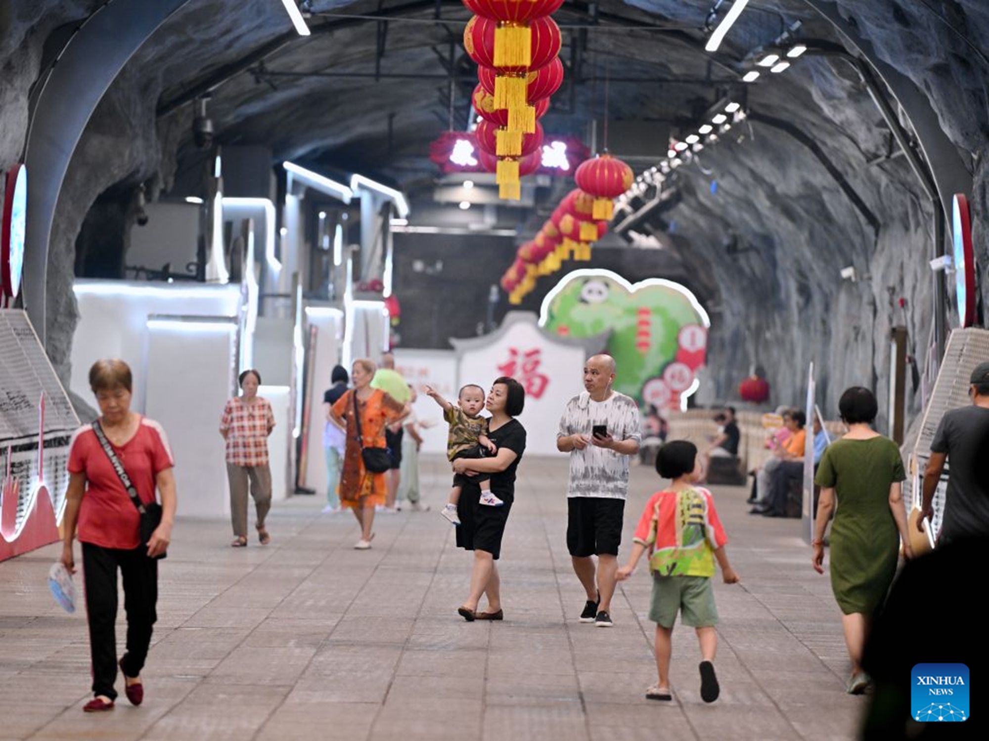 Residents relax at an air-raid shelter to cool off in Fuzhou, southeast China's Fujian Province, July 23, 2026. As summer temperatures soar, Fuzhou has made some tunnels, air-raid shelters and metro stations available as public cooling spaces. Equipped with benches, chairs and other convenience facilities, these sites have become popular for residents to relax and escape the heat. (Xinhua/Jiang Kehong)