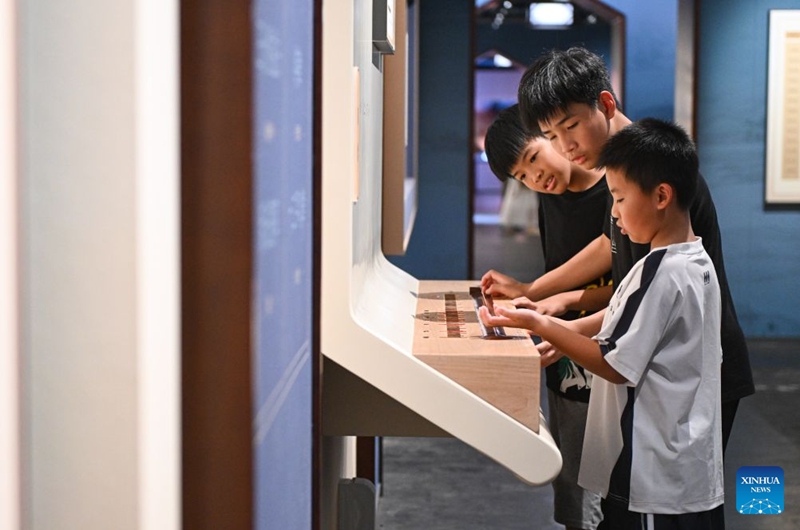 Children interact with an installation at the Divine Music Administration inside the Temple of Heaven Park in Beijing, capital of China, July 24, 2026. The renovated Divine Music Administration has opened to the public since February in 2026, it also serves as a main exhibition area of the museum of the Temple of Heaven since June this year. Marking the second anniversary of the successful inscription of the Beijing Central Axis on the UNESCO World Heritage List, heritage sites along the Beijing Central Axis, such as the Palace Museum, Zhengyangmen Gate, and Altar of the God of Agriculture, also referred to as the Xiannongtan Temple, will either open to the public free of charge or launch new exhibitions on July 27.
Over the past two years, efforts to conserve, inherit and make good use of the Beijing Central Axis have advanced steadily, achieving new outcomes in areas including related legal system, UNESCO World Heritage signage, landscape improvement, creative utilization, collaborative protection and international communication. Photo: Xinhua