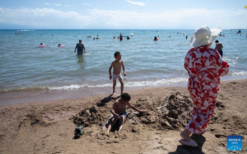 Children play on the shore of Issyk-Kul Lake in Kyrgyzstan, on July 23, 2026. Issyk-Kul Lake, located in the northeastern part of Kyrgyzstan, covers an area of more than 6,000 square kilometers and ranks as the world's second-largest alpine lake. (Xinhua/Li Renzi)