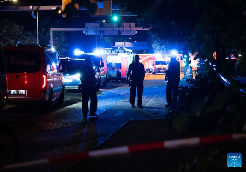 Police officers work near the site where a car drove into a crowd in Berlin, Germany, July 26, 2026. One person was killed and 16 others were injured, including several with life-threatening injuries, after a car drove into a crowd at a large Pride celebration in central Berlin on Saturday evening, a police spokesperson said. (Xinhua/Zhang Haofu)