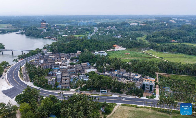 An aerial drone photo taken on July 21, 2026 shows a view of Hainan's round-the-island highway and Nanqiang Village in Boao Town, Qionghai City, south China's Hainan Province. Building on the unique identities of Boao Town, home to the Boao Forum for Asia, and Tanmen Town, a historic fishing port with a thousand-year legacy, Qionghai City has been advancing the coordinated construction of picturesque rural villages across the Boao-Tanmen area. Taking advantage of Hainan's round-the-island highway, the city has linked both newly constructed and previously cultivated beautiful and harmonious villages into a cohesive chain to forge a globally influential rural revitalization belt. Photo: Xinhua