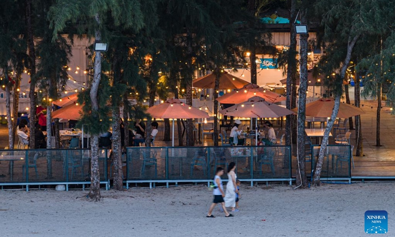 A drone photo taken on July 24, 2026 shows tourists dinning at a sea-view restaurant in Paigang Village of Tanmen Town, Qionghai City, south China's Hainan Province. Building on the unique identities of Boao Town, home to the Boao Forum for Asia, and Tanmen Town, a historic fishing port with a thousand-year legacy, Qionghai City has been advancing the coordinated construction of picturesque rural villages across the Boao-Tanmen area. Taking advantage of Hainan's round-the-island highway, the city has linked both newly constructed and previously cultivated beautiful and harmonious villages into a cohesive chain to forge a globally influential rural revitalization belt. Photo: Xinhua