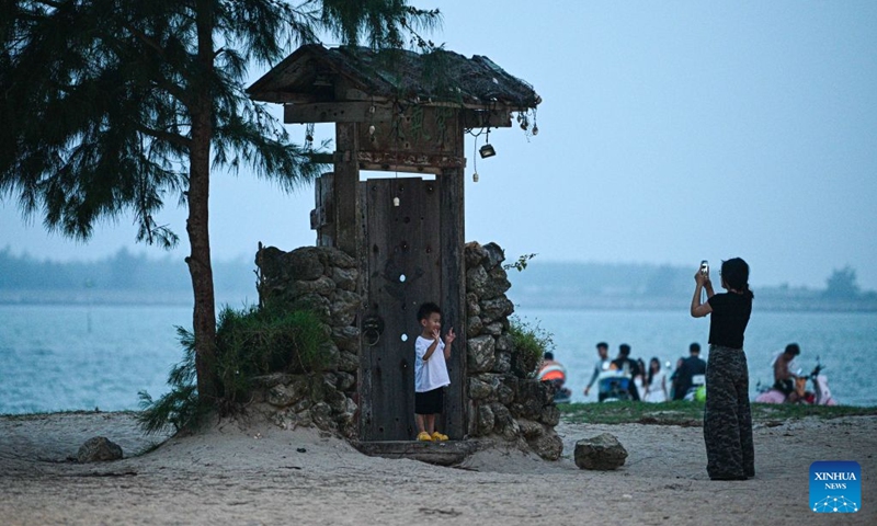 People enjoy leisure time at Paigang Village of Tanmen Town in Qionghai City, south China's Hainan Province, July 21, 2026. Building on the unique identities of Boao Town, home to the Boao Forum for Asia, and Tanmen Town, a historic fishing port with a thousand-year legacy, Qionghai City has been advancing the coordinated construction of picturesque rural villages across the Boao-Tanmen area. Taking advantage of Hainan's round-the-island highway, the city has linked both newly constructed and previously cultivated beautiful and harmonious villages into a cohesive chain to forge a globally influential rural revitalization belt. Photo: Xinhua