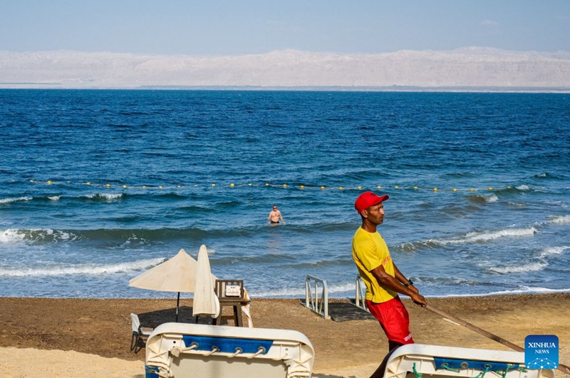 A man relaxes in the Dead Sea in Jordan, on July 25, 2026. The Dead Sea has been experiencing a long-term decline in its water level due to reduced inflow from the Jordan River, the region's naturally high evaporation rates, and industrial mineral extraction. Available data show that as of July 2026, the Dead Sea's surface was approximately 440 meters below sea level, and its water level has been declining by an average of more than one meter annually. (Xinhua/Xin Mengchen)