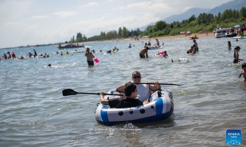 People enjoy themselves at Issyk-Kul Lake in Kyrgyzstan, on July 23, 2026. Issyk-Kul Lake, located in the northeastern part of Kyrgyzstan, covers an area of more than 6,000 square kilometers and ranks as the world's second-largest alpine lake. (Xinhua/Li Renzi)