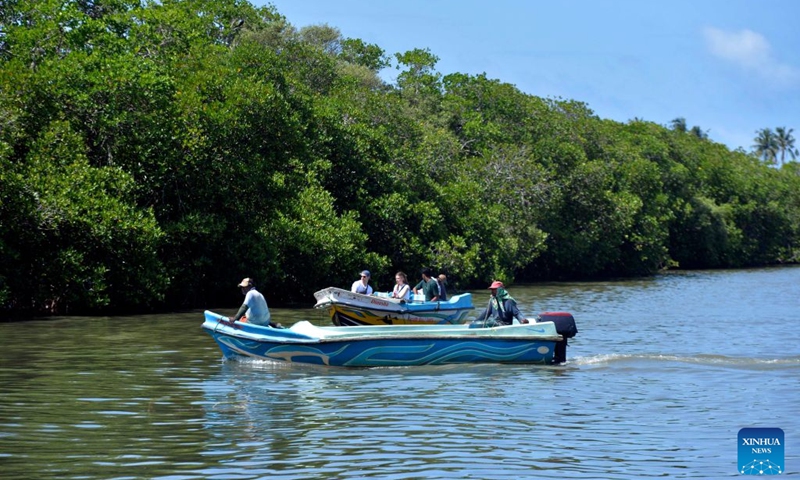 People boat near the mangroves in the Negombo Lagoon in Negombo, Sri Lanka on July 24, 2026. July 26 marks the International Day for the Conservation of the Mangrove Ecosystem. Sri Lanka's mangroves play an important role in purifying seawater, buffering coastal storms, sequestering carbon and sustaining biodiversity. (Photo by Gayan Sameera/Xinhua)