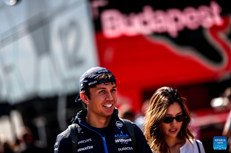 Williams' Alexander Albon (L) of Thailand arrives at the paddock before the third free practice session of the Formula One Hungarian Grand Prix at the Hungaroring in Mogyorod, near Budapest, Hungary, July 25, 2026. (Photo by David Balogh/Xinhua)
