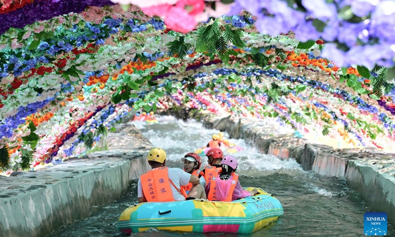 Tourists enjoy rafting at the grand canyon rafting scenic area in Pingshan County of Shijiazhuang, north China's Hebei Province, July 26, 2026. Shijiazhuang City has leveraged the high-quality mountain and water resources of the Taihang Mountains to develop distinctive cultural tourism experience programs in recent years, attracting a large influx of tourists for summer retreats. (Photo by Feng Yichao/Xinhua)