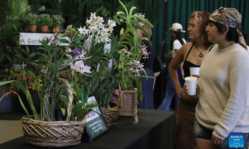 People look at flowers at an orchids trade fair at Golden Gate Park of San Francisco, the United States, July 25, 2026. (Photo by Liu Yilin/Xinhua)