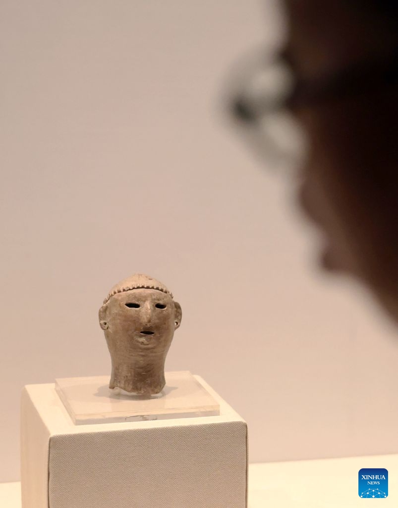 A visitor view exhibits at the exhibition Smiles: Imprints of the Chinese Spirit in Cultural Relics at the Liaoning Provincial Museum in Shenyang, northeast China's Liaoning Province, July 26, 2026.