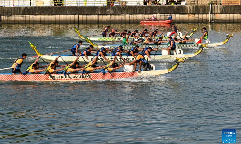 Teams compete in a dragon boat race during the Cisadane Festival in Tangerang, Banten Province, Indonesia, July 26, 2026.