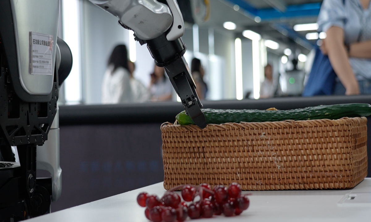 A robot arm picks up a cucumber at the Humanoid Robot Data Training Center in Shijingshan district, Beijing on July 22, 2026. Photo: Pang Yue/GT