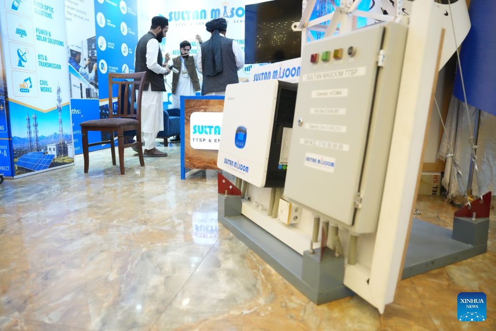 An exhibitor introduces a communication technology product to a visitor during a telecommunications and technology exposition in Kabul, Afghanistan, July 26, 2026.(Photo by Saifurahman Safi/Xinhia)

