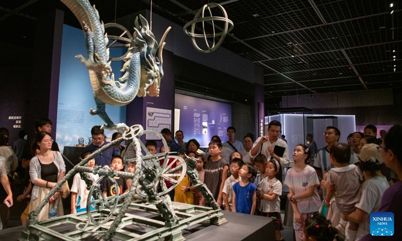 People visit Ningbo Museum in Ningbo, east China's Zhejiang Province, July 25, 2026. Museums have become popular in hot summer in many regions across China, drawing large crowds seeking both knowledge and coolness. (Photo by Zhang Hui/Xinhua)