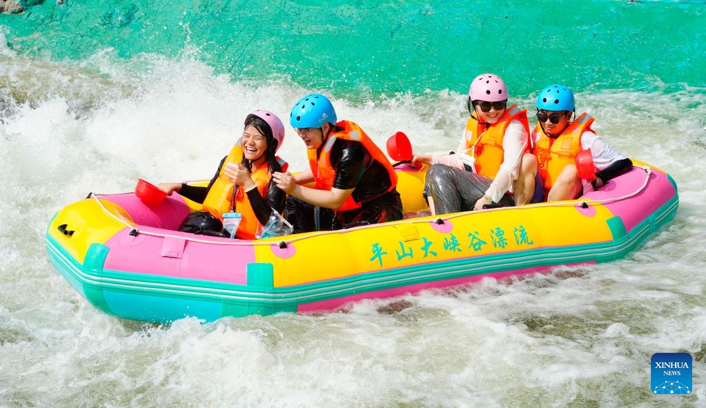 Tourists enjoy rafting at the grand canyon rafting scenic area in Pingshan County of Shijiazhuang, north China's Hebei Province, July 26, 2026. Shijiazhuang City has leveraged the high-quality mountain and water resources of the Taihang Mountains to develop distinctive cultural tourism experience programs in recent years, attracting a large influx of tourists for summer retreats. (Photo by Yan Zhiguo/Xinhua)
